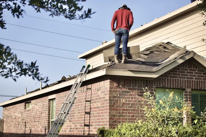 Professional roofer working on a residential roof in Parkway Village
